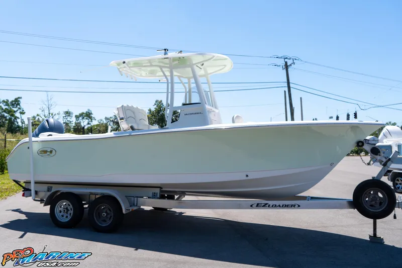 Slide: The Image of 2019 Sea Hunt Ultra 234 boat on trailer, side view, outdoors, clear sky. - 10