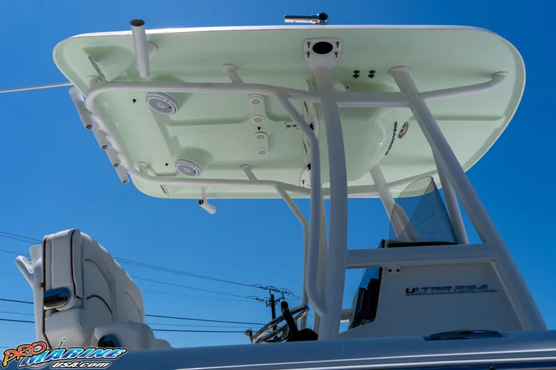 Slide: The Image of 2019 Sea Hunt Ultra 234 boat with T-top and speakers against blue sky. - 11
