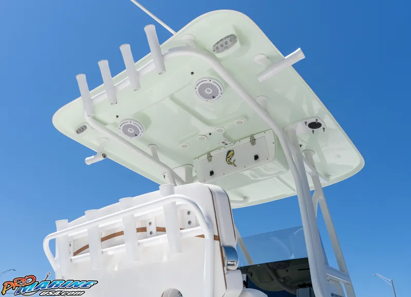 Slide: The Image of 2019 Sea Hunt Ultra 234 boat with T-top and rod holders against clear blue sky. - 12