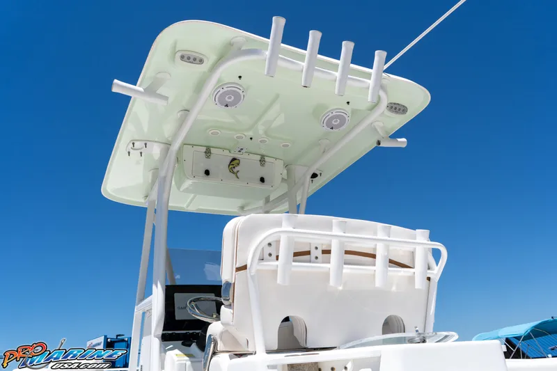 Slide: The Image of 2019 Sea Hunt Ultra 234 boat with T-top and rod holders against clear blue sky. - 14