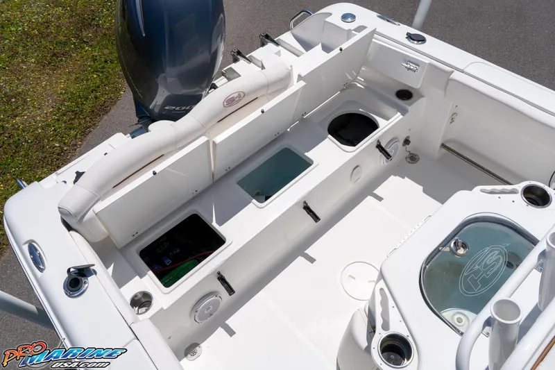 Slide: The Image of 2019 Sea Hunt Ultra 234 boat interior with storage compartments and seating. - 17