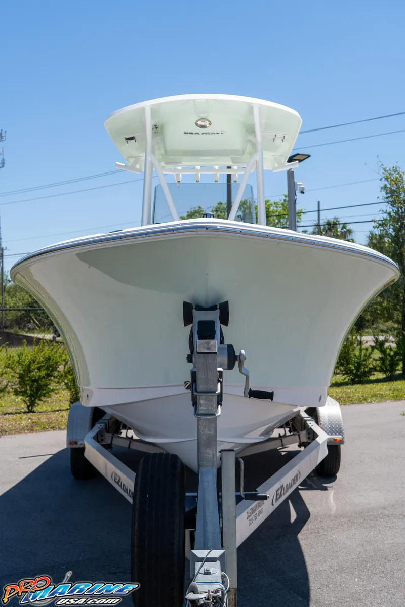 Slide: The Image of 2019 Sea Hunt Ultra 234 boat on trailer, front view, sunny day. - 2
