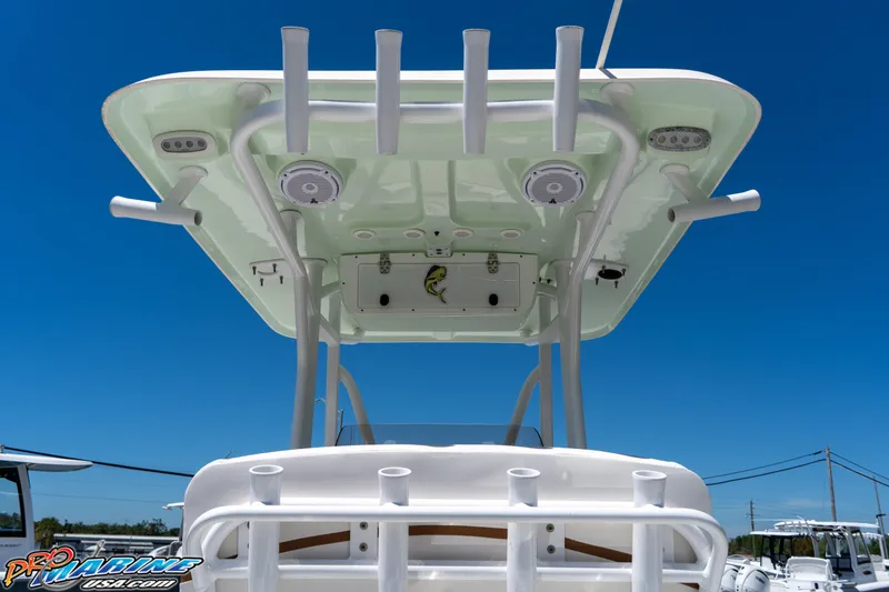 Slide: The Image of 2019 Sea Hunt Ultra 234 boat with T-top and rod holders against clear blue sky. - 20