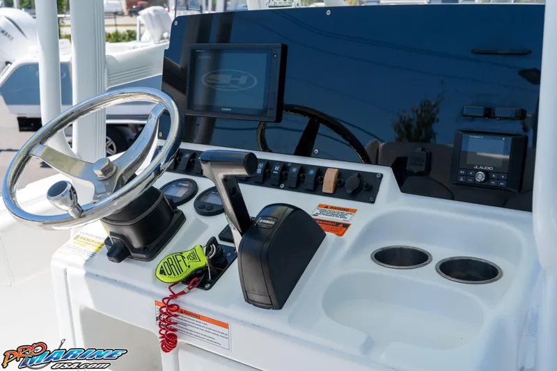 Slide: The Image of 2019 Sea Hunt Ultra 234 boat dashboard with steering wheel and electronic controls. - 21