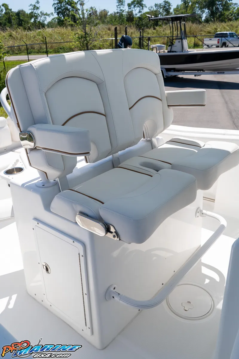 Slide: The Image of 2019 Sea Hunt Ultra 234 boat with dual white cushioned seats and armrests. - 24