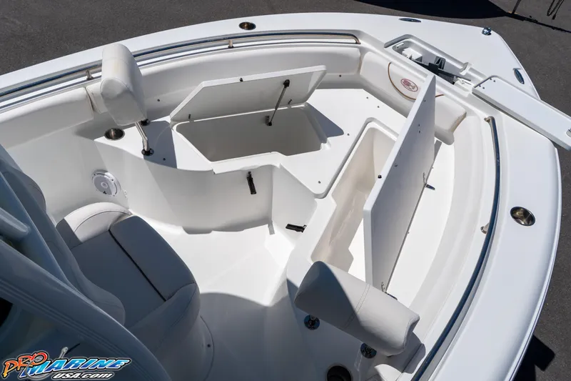 Slide: The Image of 2019 Sea Hunt Ultra 234 boat interior with open storage compartments and seating. - 26