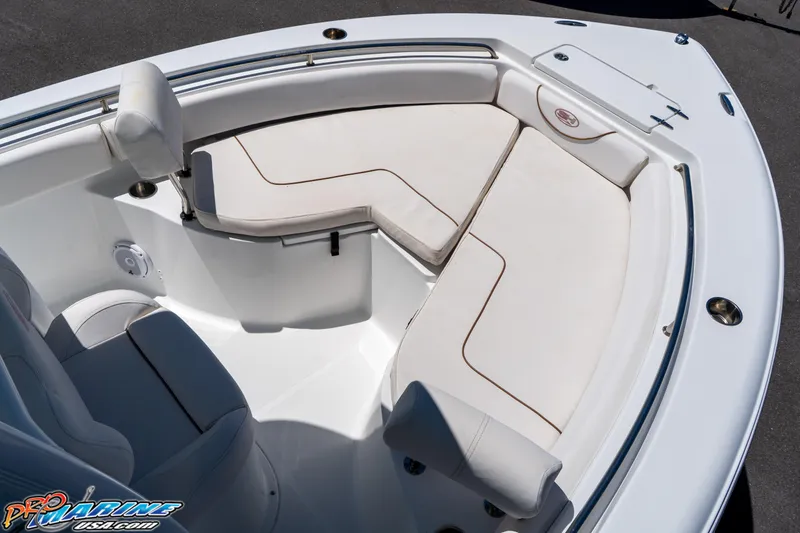 Slide: The Image of 2019 Sea Hunt Ultra 234 boat interior with white cushioned seating. - 27