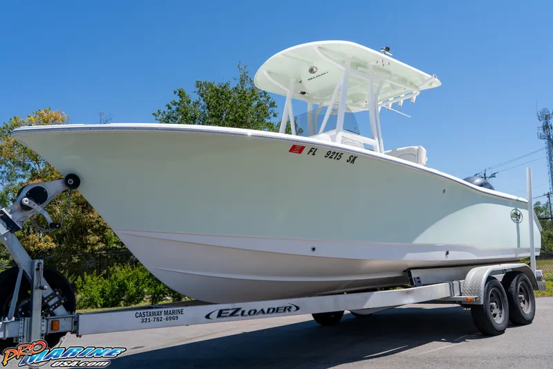 Slide: The Image of 2019 Sea Hunt Ultra 234 boat on trailer, sunny day, clear blue sky. - 4