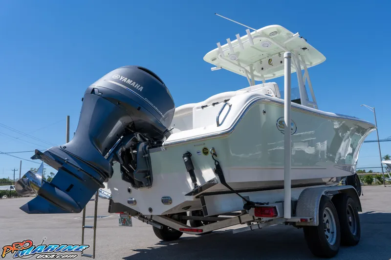 Slide: The Image of 2019 Sea Hunt Ultra 234 boat with Yamaha engine on trailer, sunny day. - 9