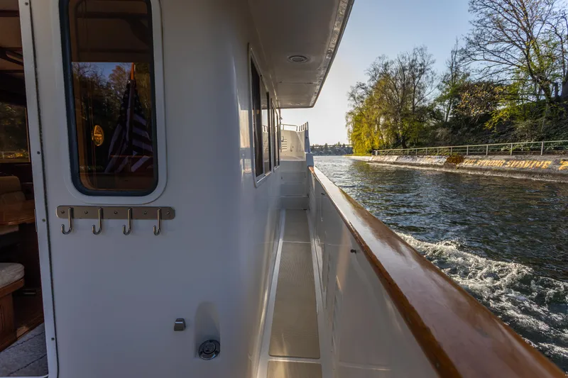 Slide: The Image of Side view of 2003 Selene 47 yacht cruising along a scenic waterway. - 13