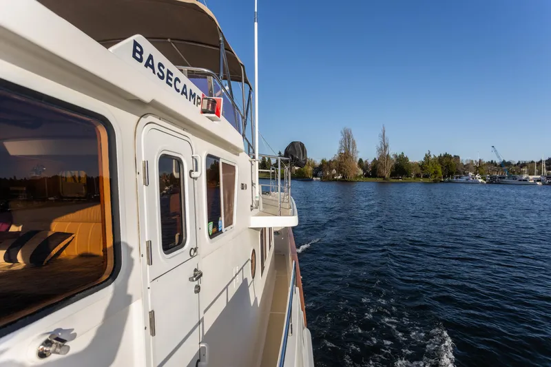 Slide: The Image of Selene 47 yacht cruising on a sunny day, 2003 model, near a scenic shoreline. - 17