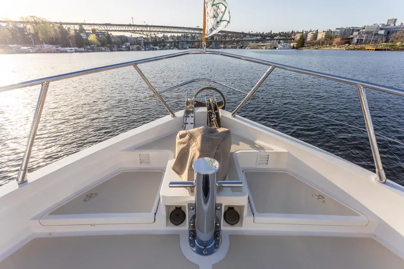 Slide: The Image of Bow view of 2003 Selene 47 yacht on calm water near a bridge. - 18