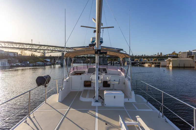 Slide: The Image of Luxurious 2003 Selene 47 yacht on calm water near a bridge at sunset. - 23