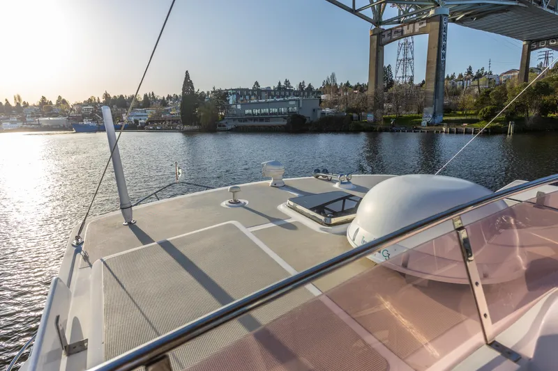 Slide: The Image of 2003 Selene 47 yacht on calm water near a bridge, scenic waterfront view. - 24