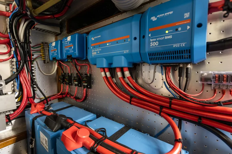 Slide: The Image of Electrical system with blue Victron Energy components and red cables in a 2003 Selene 47 yacht. - 29