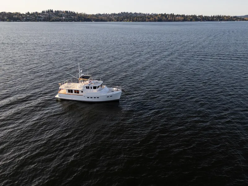 Slide: The Image of A 2003 Selene 47 yacht cruising on a calm, expansive lake. - 32