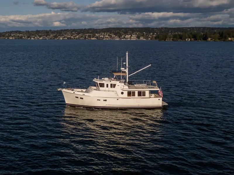 Slide: The Image of 2003 Selene 47 yacht cruising on a calm lake under a partly cloudy sky. - 35