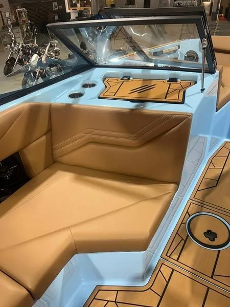 Slide: The Image of 2025 ATX Surf Boats 20 Type-S interior with tan seating and blue accents. - 4