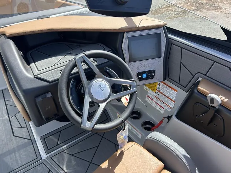 Slide: The Image of 2025 ATX Surf Boats 22 Type-S dashboard with steering wheel and touchscreen display. - 2