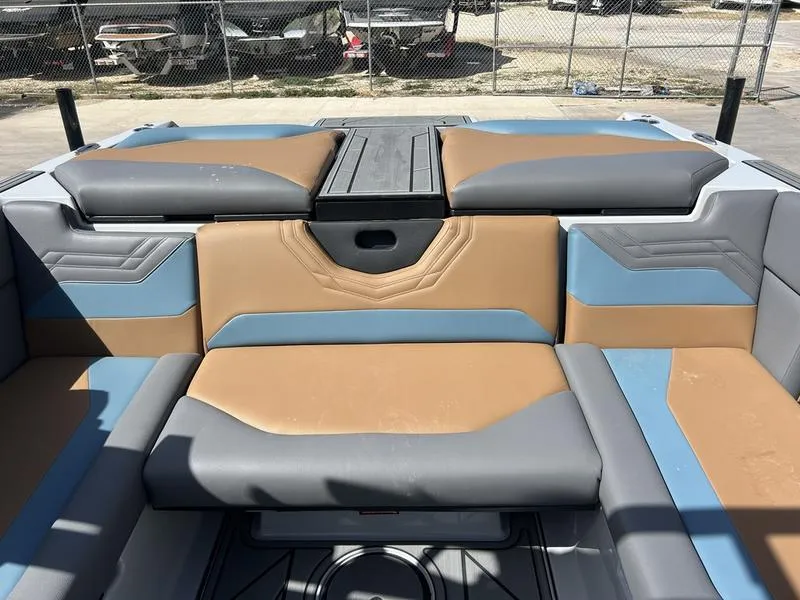 Slide: The Image of 2025 ATX Surf Boats 22 Type-S interior with tan and gray seating, outdoor setting. - 3