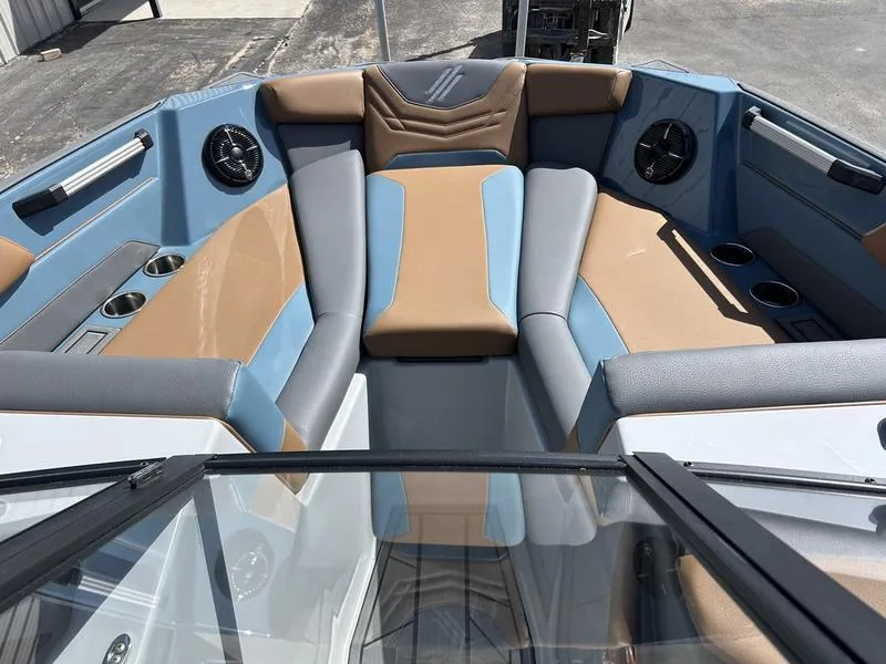 Slide: The Image of 2025 ATX Surf Boats 22 Type-S interior with blue and tan seating, cup holders, and speakers. - 5