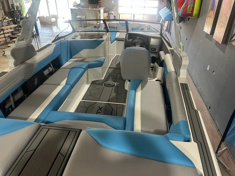 Slide: The Image of 2025 ATX Surf Boats 24 Type-S interior with blue and gray seating, modern design. - 1