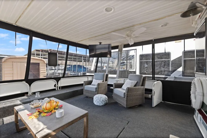 Slide: The Image of 1998 Sharpe 16 X 80 Widebody houseboat interior with cozy seating and decor. - 12