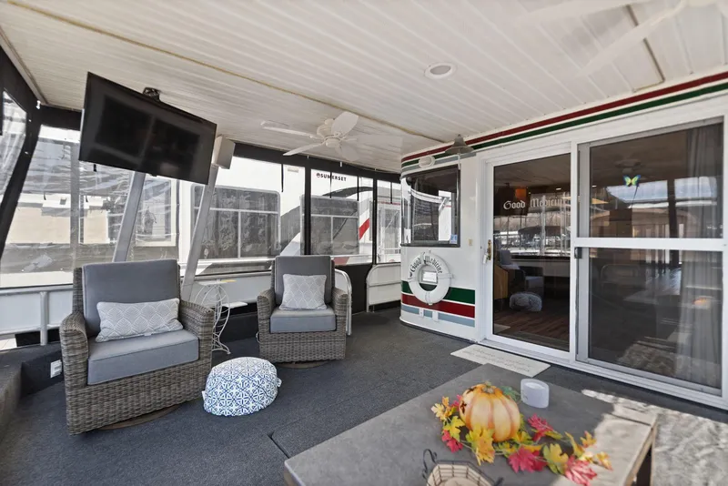 Slide: The Image of 1998 Sharpe 16 X 80 Widebody Houseboat interior with cozy seating and decor. - 13