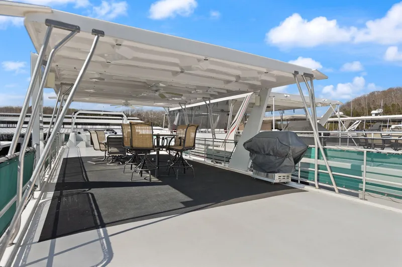 Slide: The Image of 1998 Sharpe 16 X 80 Widebody Houseboat with covered deck and outdoor seating. - 25