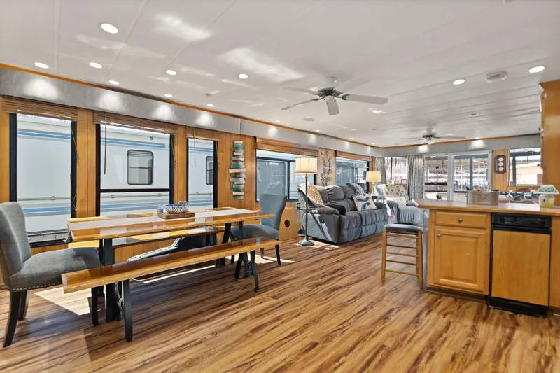 Slide: The Image of Interior of a 1998 Sharpe 16 X 80 Widebody Houseboat with modern furnishings and wood flooring. - 31