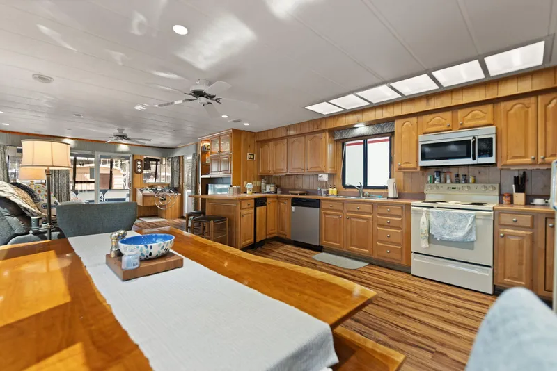 Slide: The Image of Interior of 1998 Sharpe 16 X 80 Widebody Houseboat with spacious kitchen and dining area. - 32