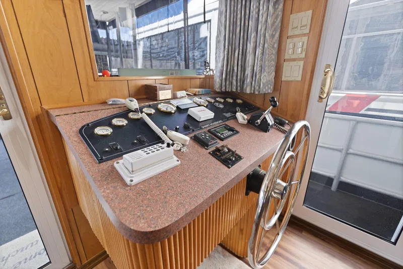 Slide: The Image of 1998 Sharpe houseboat helm with steering wheel and control panel. - 34