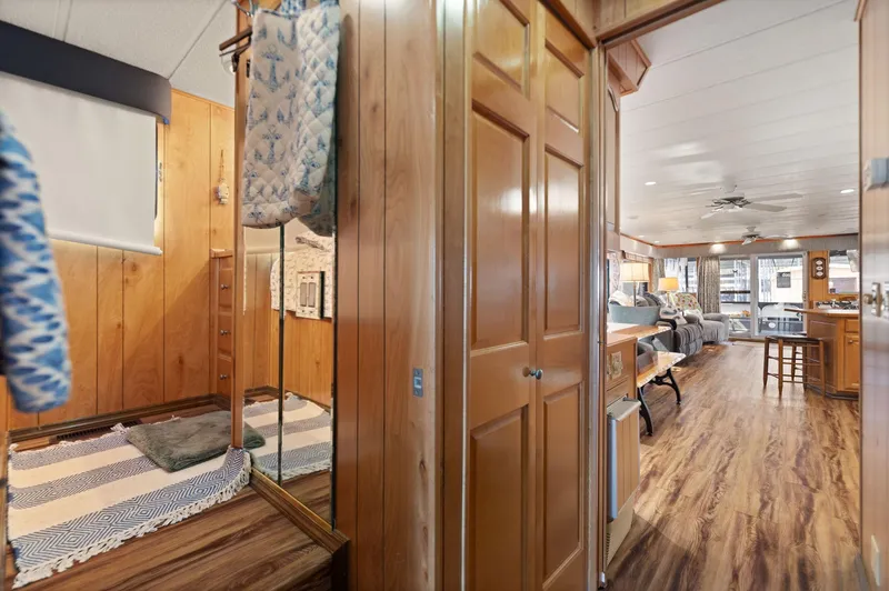 Slide: The Image of Interior of 1998 Sharpe 16 X 80 Widebody Houseboat with wood paneling and cozy decor. - 36