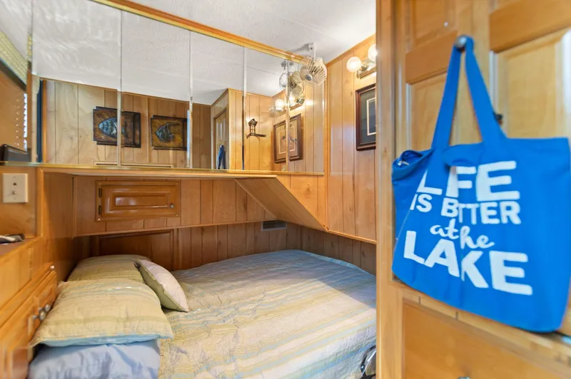 Slide: The Image of Cozy bedroom in 1998 Sharpe houseboat with wood paneling and decorative accents. - 37