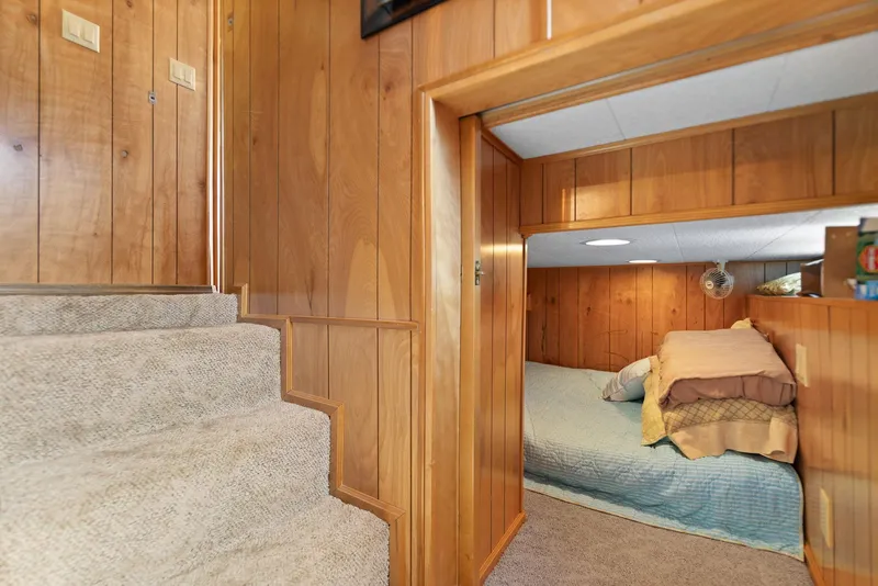 Slide: The Image of Cozy wooden interior of 1998 Sharpe houseboat with stairs and bedroom. - 38