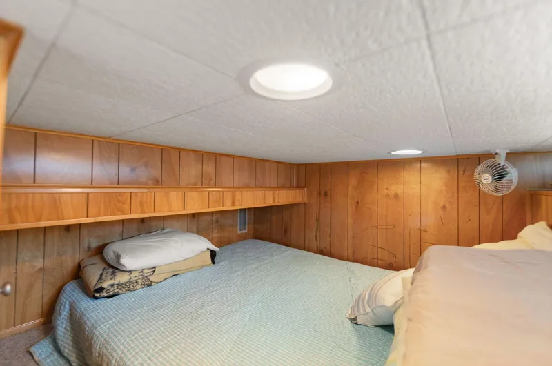 Slide: The Image of Cozy bedroom in 1998 Sharpe 16 X 80 Widebody Houseboat with wood paneling and soft lighting. - 39