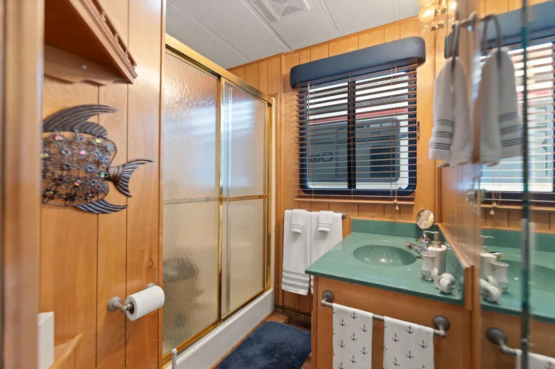 Slide: The Image of Bathroom in 1998 Sharpe 16 X 80 Widebody Houseboat with wood paneling and nautical decor. - 45