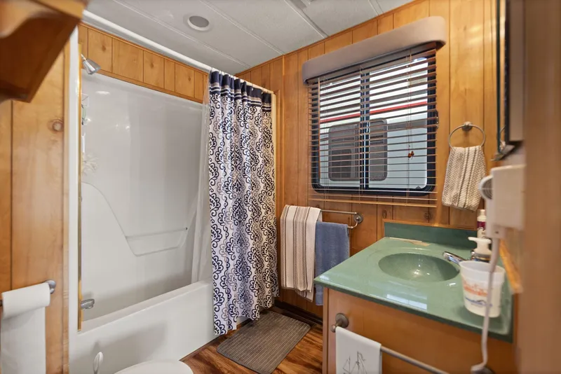 Slide: The Image of Bathroom in 1998 Sharpe 16 X 80 Widebody Houseboat with wood paneling and modern amenities. - 46