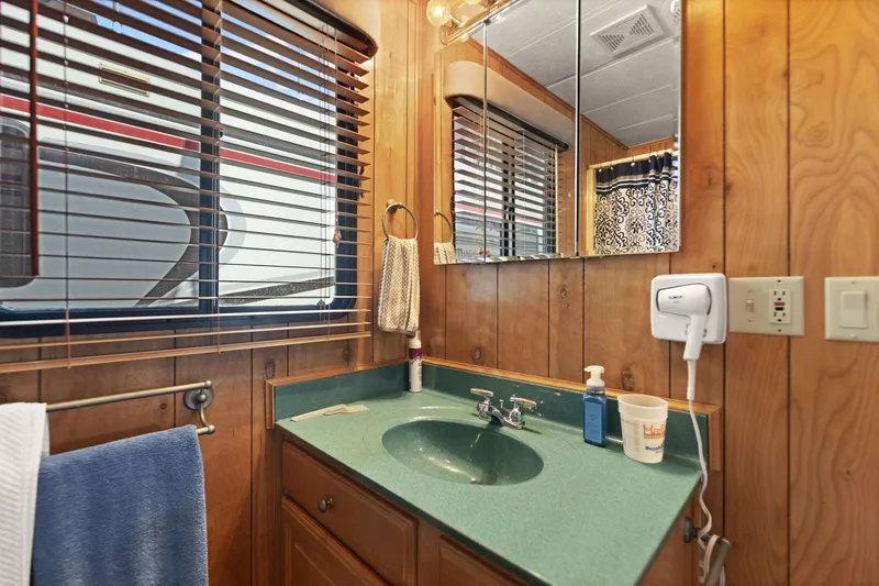 Slide: The Image of Bathroom interior of 1998 Sharpe houseboat with wood paneling and green countertop. - 47