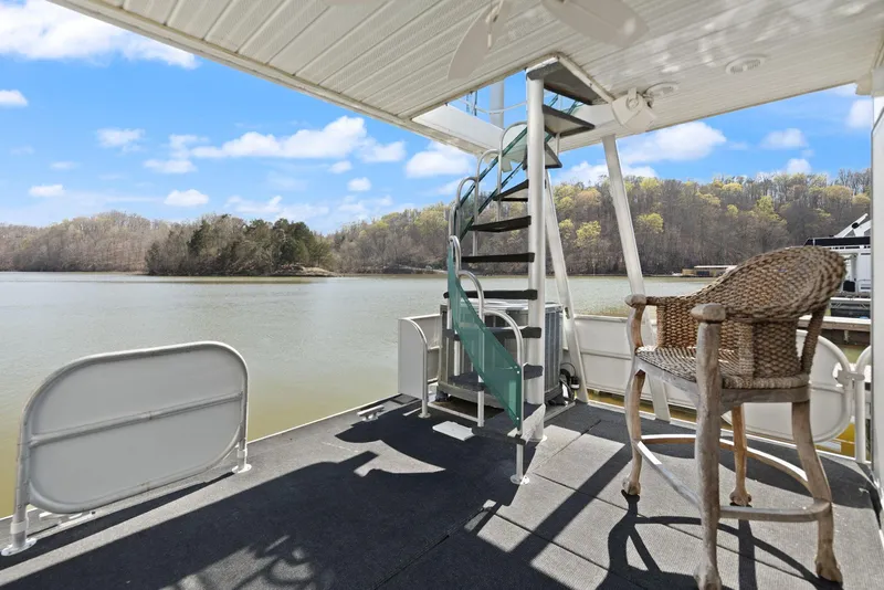 Slide: The Image of 1998 Sharpe 16 X 80 Widebody Houseboat with spiral staircase on a serene lake. - 54