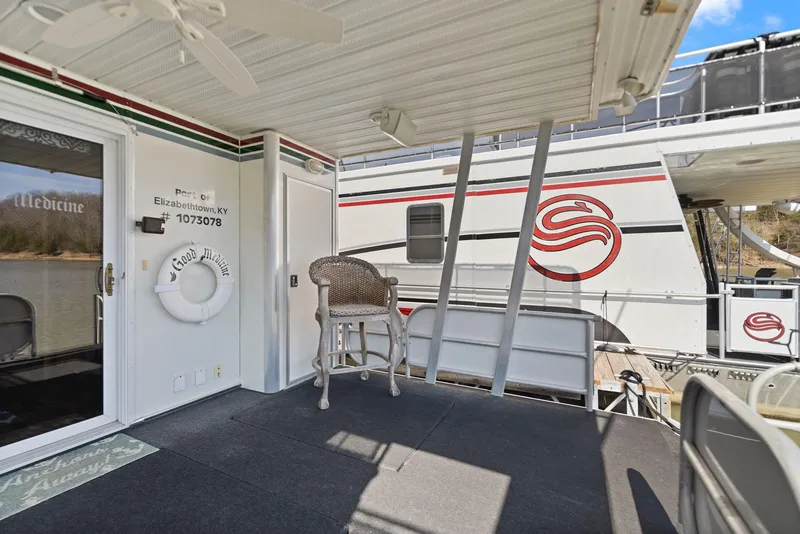 Slide: The Image of 1998 Sharpe 16 X 80 Widebody Houseboat deck with seating and life preserver. - 56