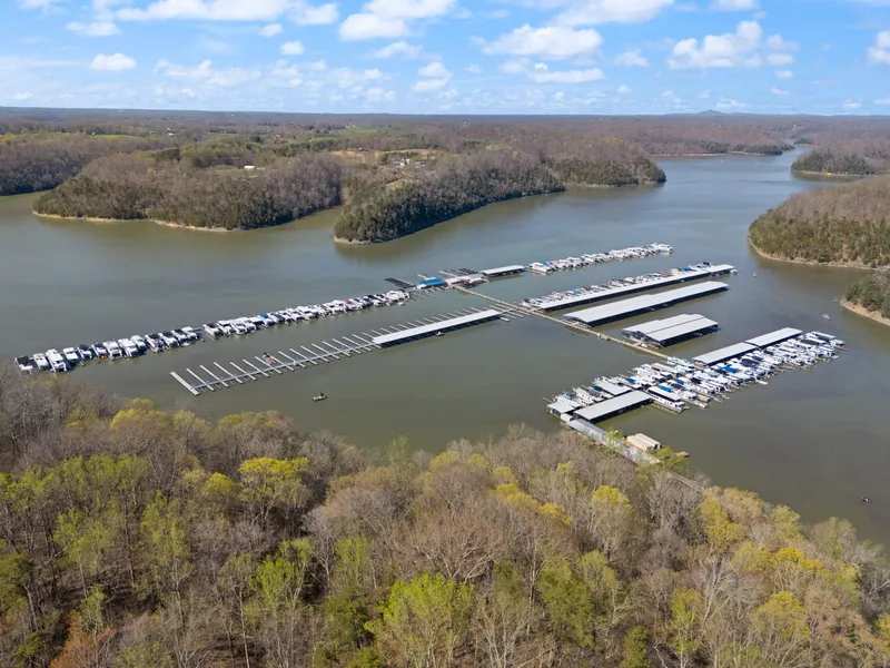 Slide: The Image of Aerial view of a marina with houseboats, including a 1998 Sharpe 16 X 80 Widebody Houseboat. - 68
