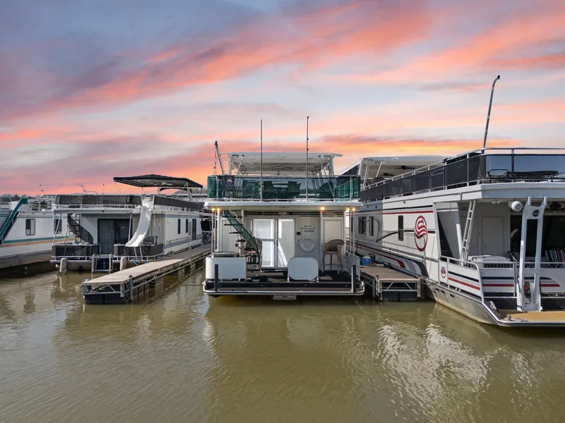 Slide: The Image of 1998 Sharpe 16 X 80 Widebody Houseboat docked at sunset, calm waters. - 9