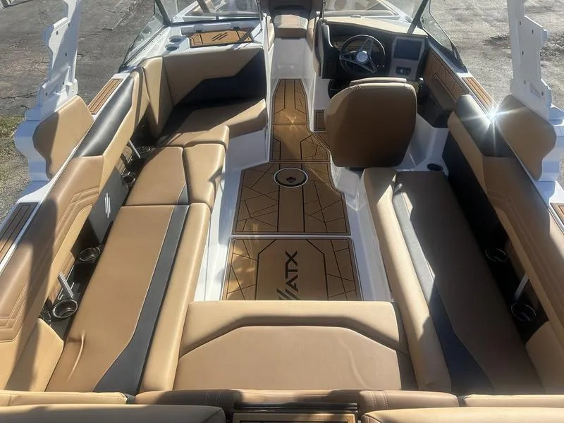 Slide: The Image of 2025 ATX Surf Boats 24 Type-S interior with tan seating and sleek design. - 2
