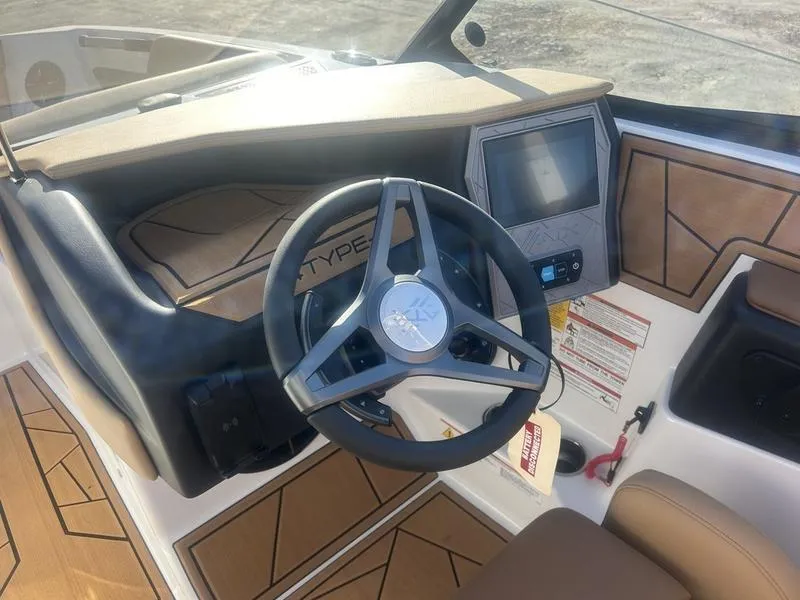 Slide: The Image of 2025 ATX Surf Boats 24 Type-S dashboard with steering wheel and touchscreen display. - 4
