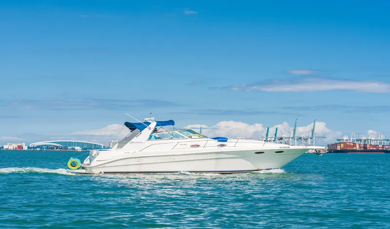 The Image of 1997 Sea Ray 330 Sundancer cruising on blue ocean under clear sky. - 0