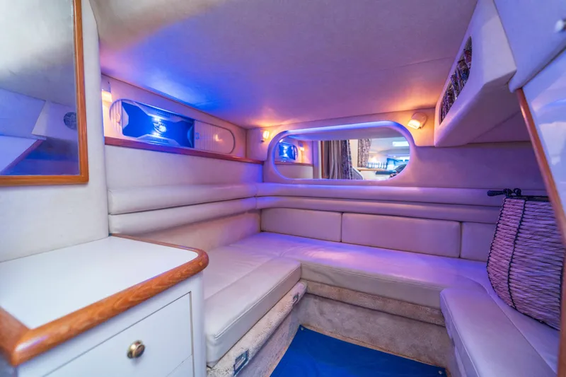 Slide: The Image of Interior of 1997 Sea Ray 330 Sundancer yacht with cozy seating and ambient lighting. - 6