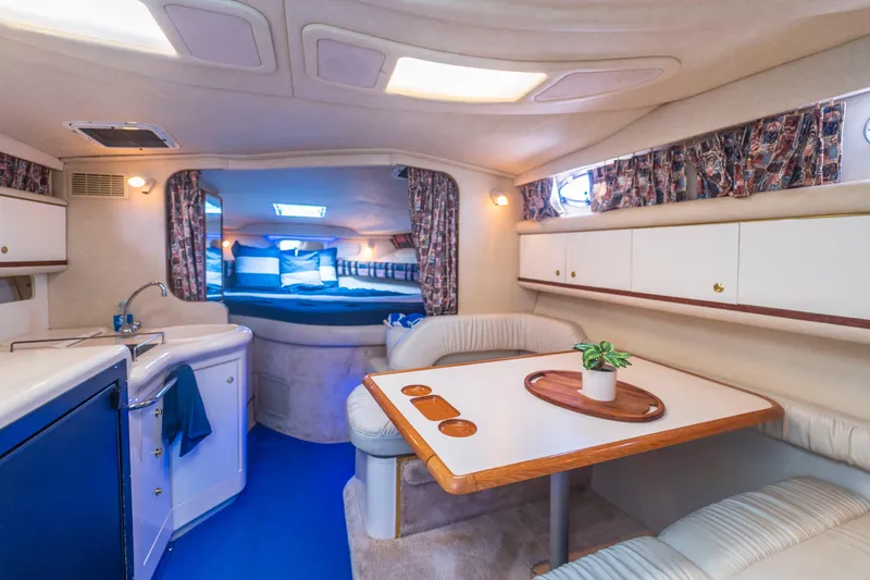 Slide: The Image of Interior of 1997 Sea Ray 330 Sundancer yacht with cozy seating and kitchenette. - 7