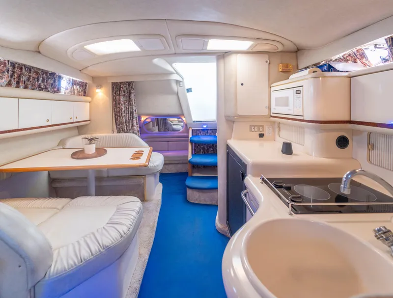 Slide: The Image of Interior of 1997 Sea Ray 330 Sundancer yacht with kitchen and seating area. - 8