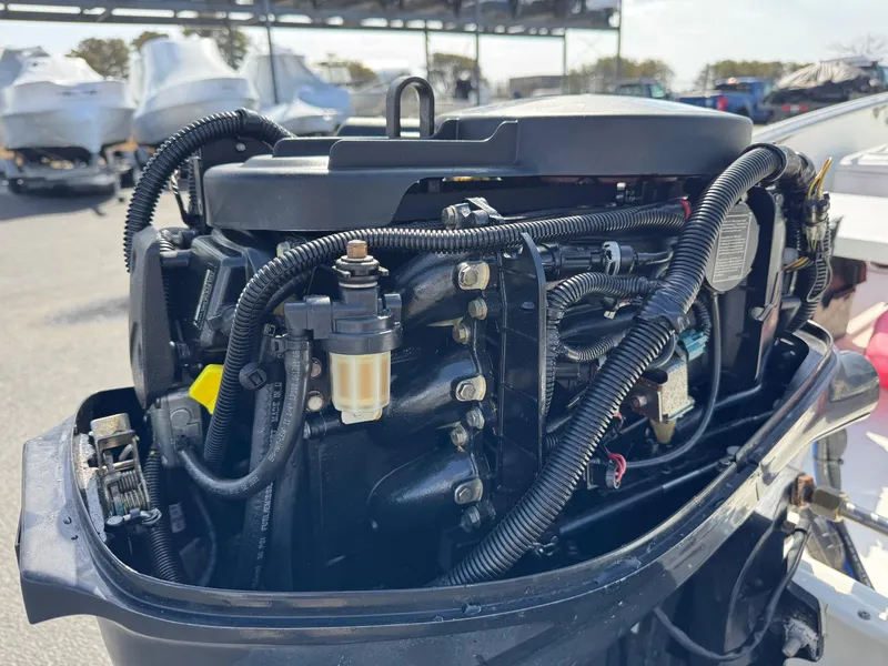 Slide: The Image of Close-up of a 2012 Boston Whaler 130 Super Sport boat engine, showcasing intricate wiring and components. - 10
